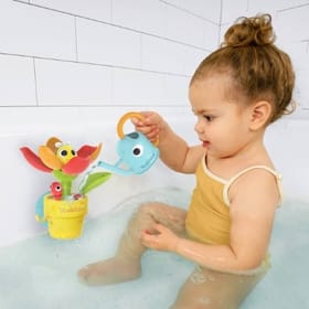 Child in the bath playing with Peek-a-Bee Tub Flower
