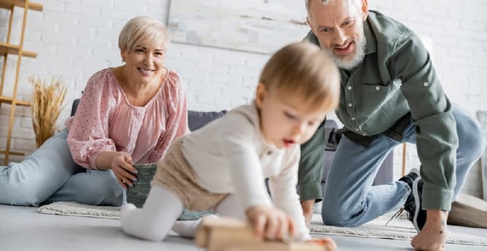 Couple Looking at Grandchild Playing