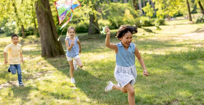 gild running happily with kite