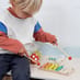Young Boy Playing with a Woodland Music Set